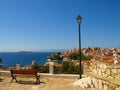 Wooden bench and street lamp with panoramic view over The Aegean Sea and Skiathos, Greece Royalty Free Stock Photo