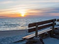 Wooden bench with sunset sea view Royalty Free Stock Photo