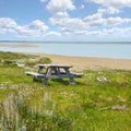 Wooden bench and table by the East Coast of Jutland, Denmark for a picnic by the sea outside. Seating furniture at the