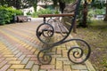 Wooden bench with twisted legs in the park Royalty Free Stock Photo