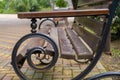 Wooden bench with twisted legs in the park Royalty Free Stock Photo