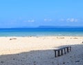 A Wooden Bench under Shade on Peaceful Secluded Sandy Beach, Blue Ocean and Sky - Laxmanpur, Neil Island, Andaman, India Royalty Free Stock Photo