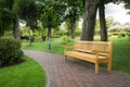 Wooden bench under trees at beautiful park Royalty Free Stock Photo