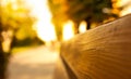 Wooden bench up close. The street is blurred. Copy space. Royalty Free Stock Photo