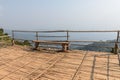 Wooden bench on wooden floor near cliff Royalty Free Stock Photo