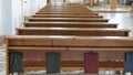 Wooden Benches in Catholic Church. Catholic Temple Seats, Blurred Background. Religious Background.