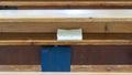 Wooden Benches in Catholic Church. Catholic Temple Seats, Blurred Background. Religious Background.
