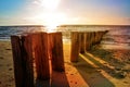 Wooden benches at the North Sea beach at sunset