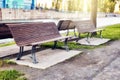 Wooden benches in a park near the riverside at sunset Royalty Free Stock Photo