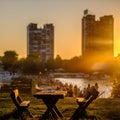 Benches and table at the Lido beach at sunset in Zemun, Serbia Royalty Free Stock Photo