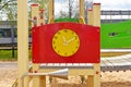 Wooden big yellow clock in children playground. Royalty Free Stock Photo