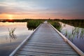 Wooden bike path on water at sunset Royalty Free Stock Photo