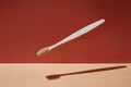 Wooden biodegradable bamboo toothbrush drops on a colored background. Health, environment and zero waste concept.