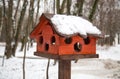 Wooden bird feeder brown with large holes on the pole. Ecology, help to nature, birds