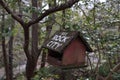 A wooden bird house with white inscription `See Rock City`