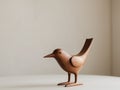 Wooden bird sculpture standing on light background. Royalty Free Stock Photo