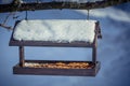 Wooden Birdfeeder on a tree in winter Royalty Free Stock Photo
