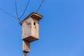 wooden birdhouse against the blue sky