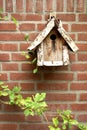 Wooden birdhouse on brick wall Royalty Free Stock Photo