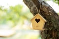 Wooden birdhouse hanging from tree in autumn garden. Concept for new home. A bird house or bird box in summer sunshine with natura Royalty Free Stock Photo