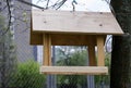 Wooden birdhouse hanging on a tree. Close-up. Bird feeders.