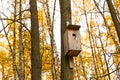 Wooden birdhouse hanging on a tree to help birds create nests taking care of nature