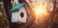 Wooden birdhouse on a trunk of an old tree