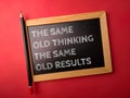 Wooden black board and pencil with the word THE SAME OLD THINKING THE SAME OLD RESULTS Royalty Free Stock Photo