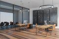 Wooden black office room with chairs and computers on parquet floor