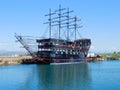 Wooden black pleasure ship with high masts
