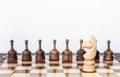 Wooden black and white chess pieces on a chessboard, horse and pawns on the background, leadership retro concept Royalty Free Stock Photo