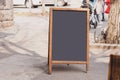 Blackboard in front of restaurant entrance. Mock up menu blank board sign stand near shop or cafe restaurant. Street Royalty Free Stock Photo