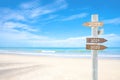 Wooden blank sign with text 2020 and 2021, Over Blurred blue sea and sand beach with cloudy blue sky Royalty Free Stock Photo
