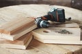 Wooden blanks for a birdhouse and a cordless screwdriver lie on a wooden table. DIY concept