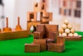 Wooden block brain teaser puzzle on green table in a blurred background Royalty Free Stock Photo