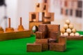 Wooden block brain teaser puzzle on green table in a blurred background Royalty Free Stock Photo