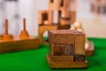 Wooden block brain teaser puzzle on green table in a blurred background Royalty Free Stock Photo