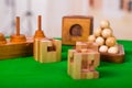 Wooden block brain teaser puzzle on green table in a blurred background Royalty Free Stock Photo