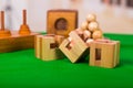 Wooden block brain teaser puzzle on green table in a blurred background Royalty Free Stock Photo