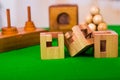 Wooden block brain teaser puzzle on green table in a blurred background Royalty Free Stock Photo