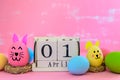 Wooden block calendar for Easter Day, April 1. Colorful of Easter eggs in nest on pastel color bright blue and white wooden Royalty Free Stock Photo