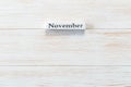 Wooden block of calendar with month November on wood background