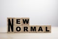 Wooden block cubes for new normal wording. The world is changing to balance it into new normal include business , economy , Royalty Free Stock Photo