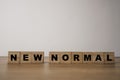 Wooden block cubes for  new normal wording. The world is changing to balance it into new normal include business , economy , Royalty Free Stock Photo