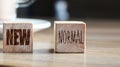 Wooden block cubes for new normal wording. The world is changing to balance it into new normal include business , economy , Royalty Free Stock Photo