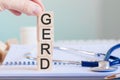 Wooden block form the word gerd with stethoscope on the doctor`s desktop, medical concept Royalty Free Stock Photo