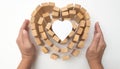 Wooden block heart and hand hold with heart paper concept