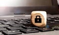 Wooden block with lock graphic on laptop keyboard. Computer security concept Royalty Free Stock Photo