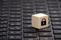 Wooden block with lock graphic on laptop keyboard. Computer security concept. Royalty Free Stock Photo