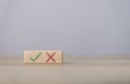 wooden block showing right and wrong sign decision concept, vote and think yes or no Business options for difficult situations